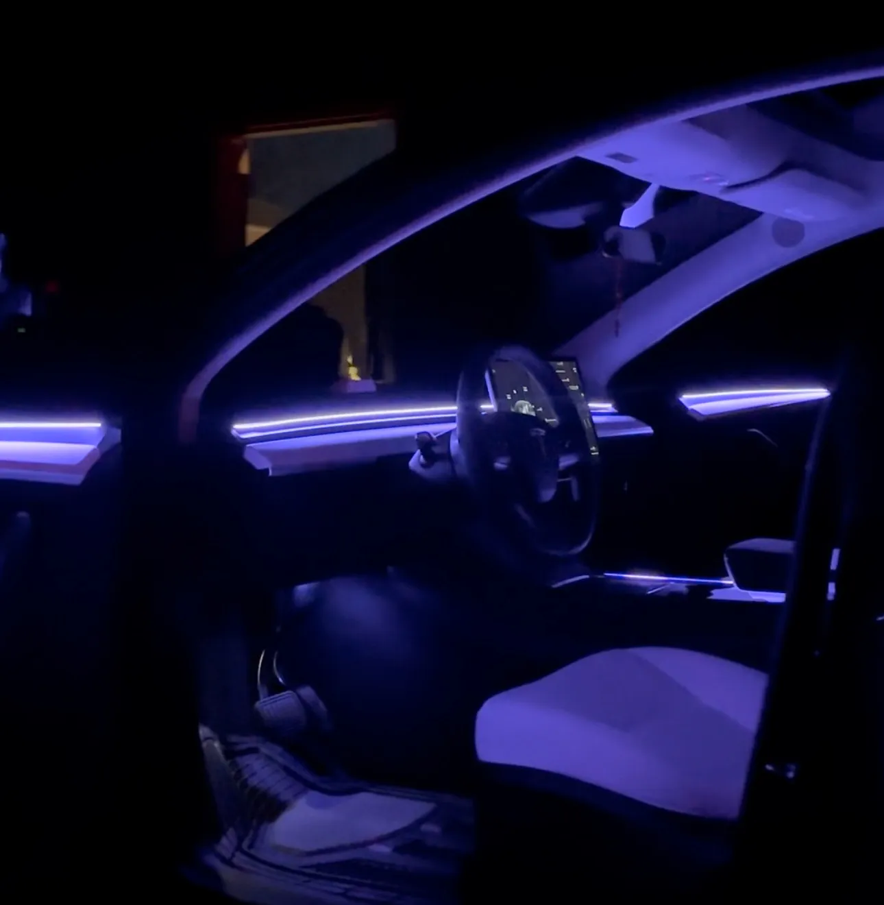 Purple ambient lighting in a car interior at night